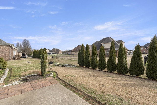 view of yard with fence and a residential view