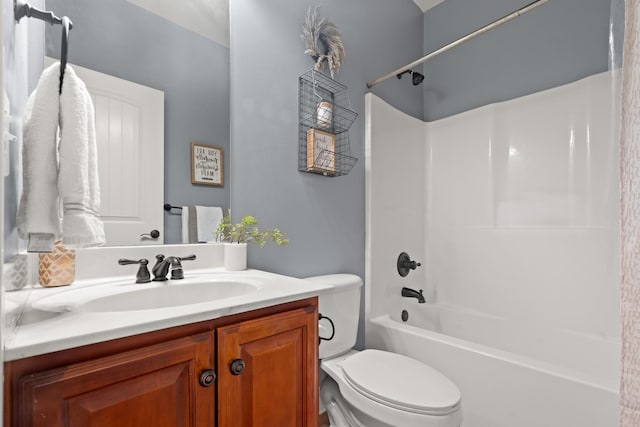 bathroom with toilet, washtub / shower combination, and vanity