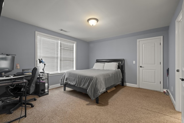 bedroom featuring baseboards, visible vents, and carpet flooring