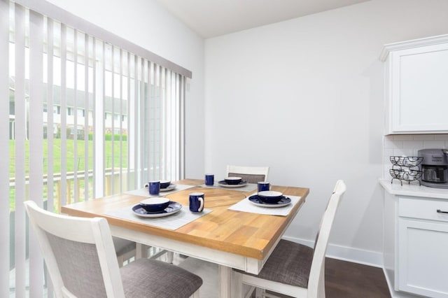 dining room with baseboards and dark wood-style flooring