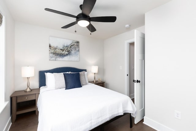 bedroom with a ceiling fan, dark wood-style flooring, and baseboards