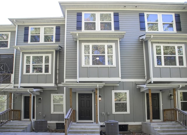 townhome / multi-family property featuring board and batten siding, cooling unit, and entry steps