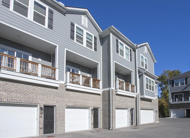 exterior space with a garage and brick siding