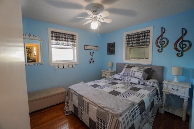 bedroom with dark wood-style floors and ceiling fan