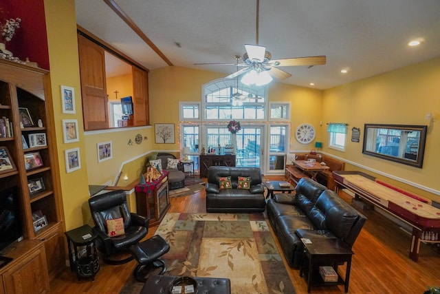 living area featuring lofted ceiling, ceiling fan, recessed lighting, and wood finished floors