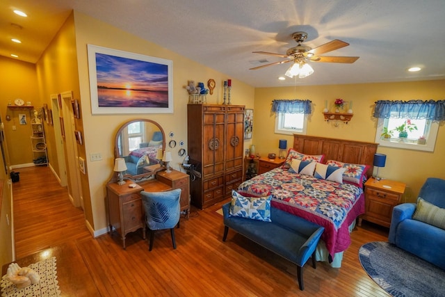 bedroom with recessed lighting, wood finished floors, a ceiling fan, baseboards, and vaulted ceiling