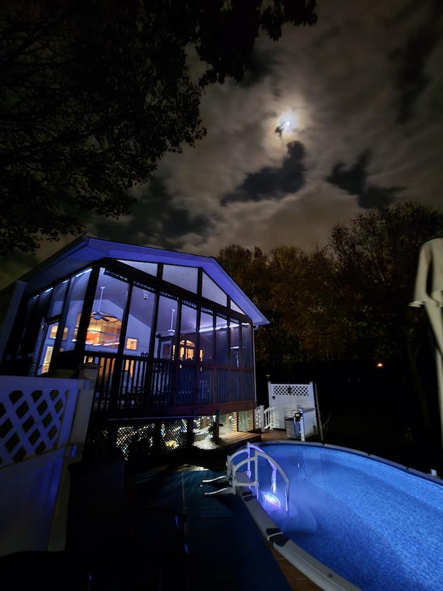 pool at dusk featuring an outdoor pool