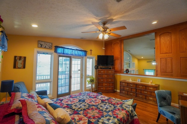 bedroom with a textured ceiling, ceiling fan, recessed lighting, access to outside, and light wood finished floors