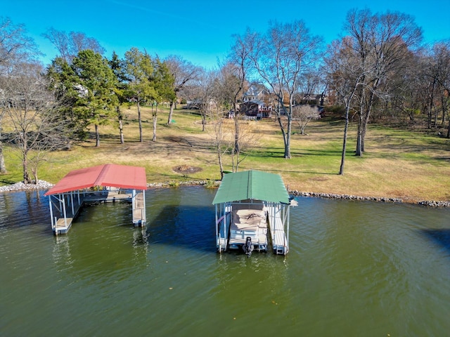 view of dock with a lawn, a water view, and boat lift