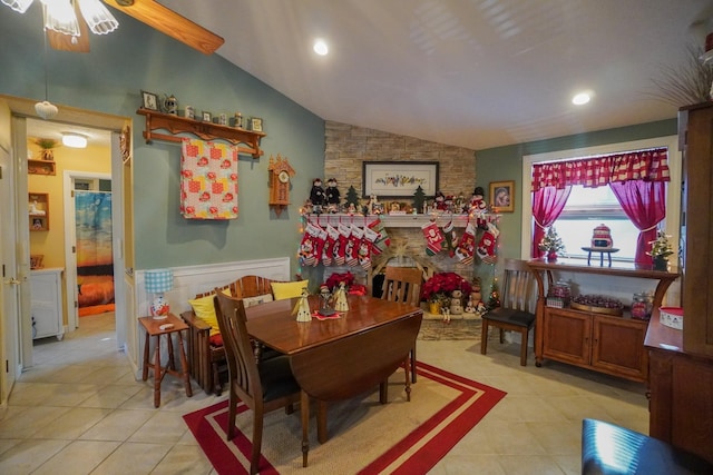 dining area featuring lofted ceiling and light tile patterned floors