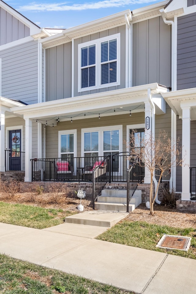 view of front of house with board and batten siding and covered porch