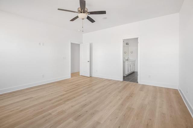 empty room with light wood-style floors, baseboards, and a ceiling fan