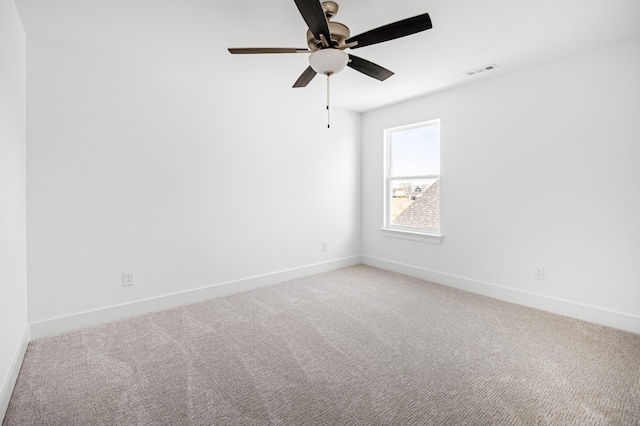 unfurnished room featuring a ceiling fan, visible vents, light carpet, and baseboards