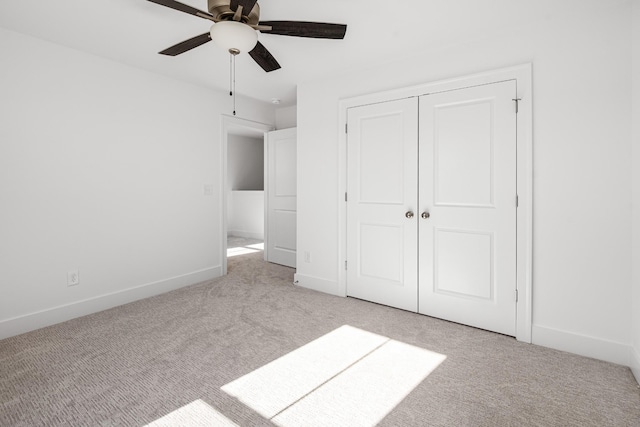 unfurnished bedroom featuring a closet, carpet flooring, ceiling fan, and baseboards