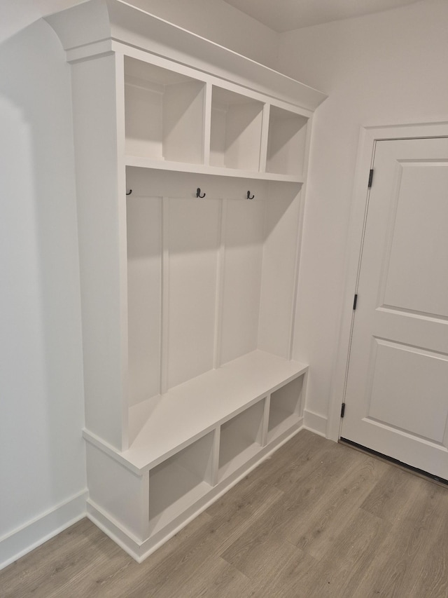 mudroom with baseboards and wood finished floors