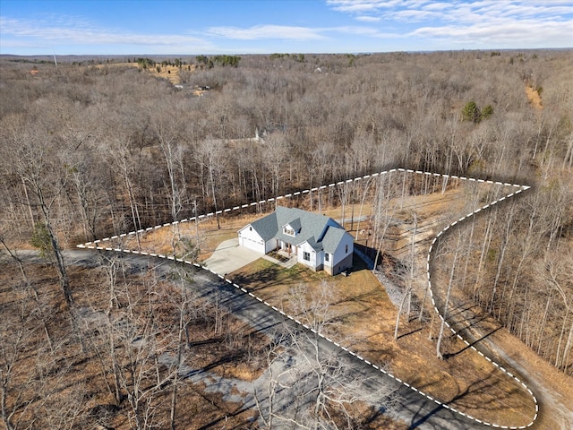 birds eye view of property with a wooded view