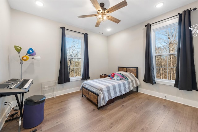 bedroom featuring recessed lighting, wood finished floors, and baseboards