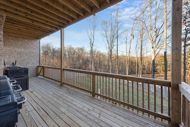 wooden deck with a forest view