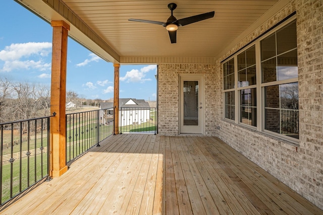 wooden terrace featuring ceiling fan