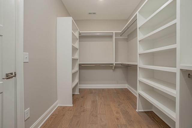 walk in closet featuring light wood-type flooring and visible vents