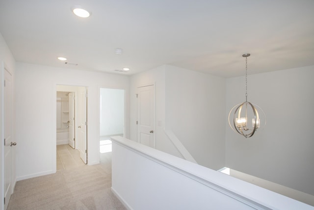 corridor featuring recessed lighting, light carpet, visible vents, baseboards, and an upstairs landing