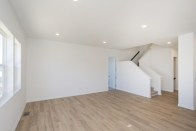 interior space with light wood-style floors, stairs, baseboards, and recessed lighting