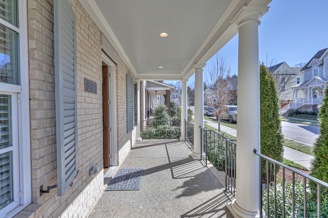 view of patio featuring covered porch and a residential view