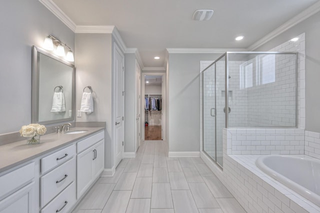 bathroom featuring a stall shower, crown molding, and vanity