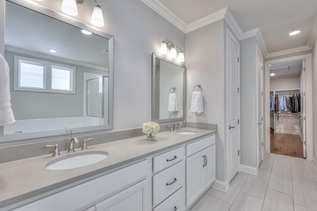 bathroom with double vanity, ornamental molding, a sink, and a shower with door