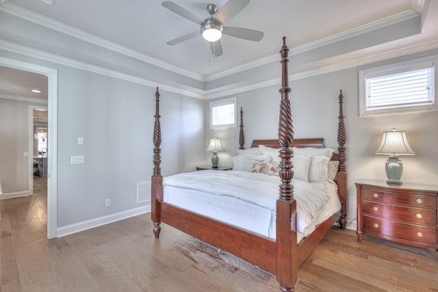 bedroom with crown molding, baseboards, and wood finished floors