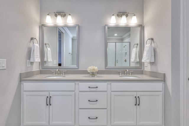 full bathroom with double vanity, a stall shower, and a sink