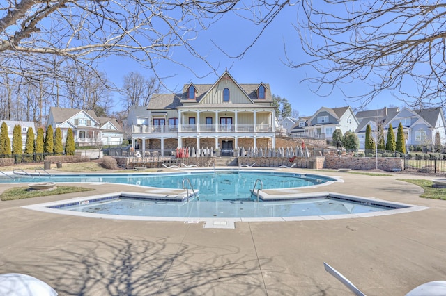 view of pool featuring a fenced in pool, a residential view, a patio area, and fence