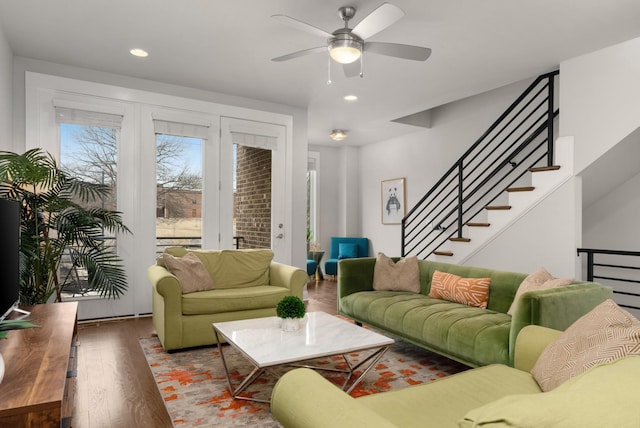 living room with ceiling fan, stairway, wood finished floors, and recessed lighting