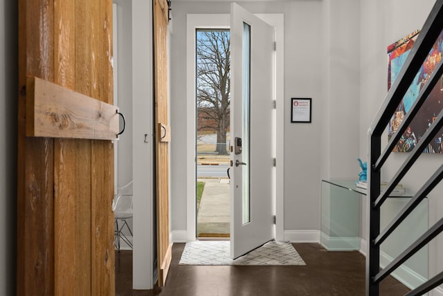 foyer entrance featuring dark wood-style flooring and baseboards