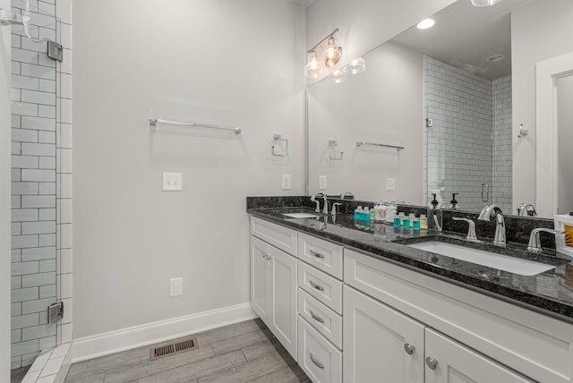 bathroom featuring a stall shower, visible vents, and a sink