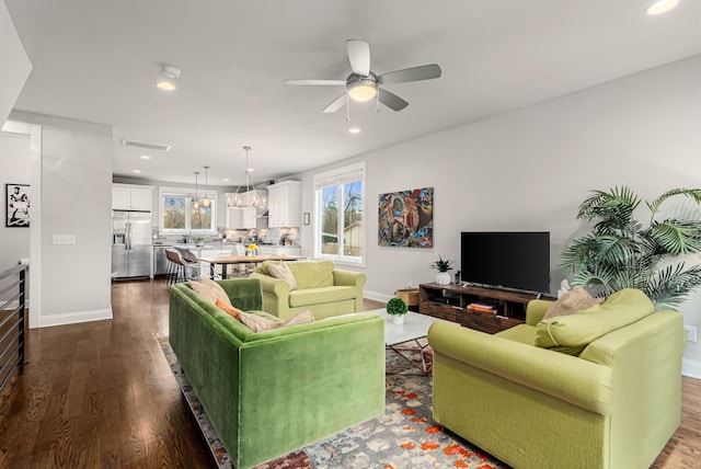 living room with baseboards, dark wood finished floors, and recessed lighting