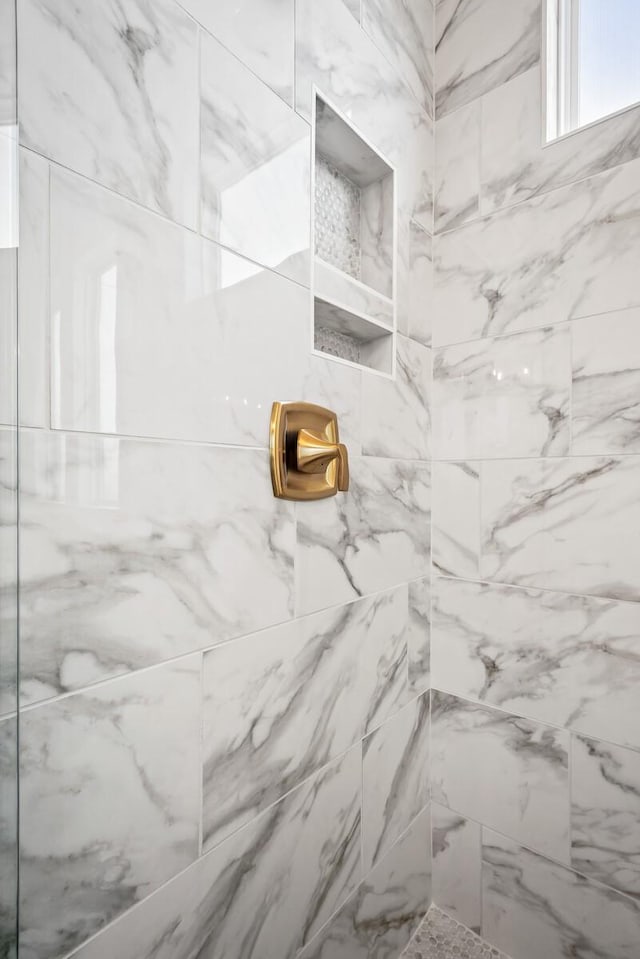 bathroom with tiled shower