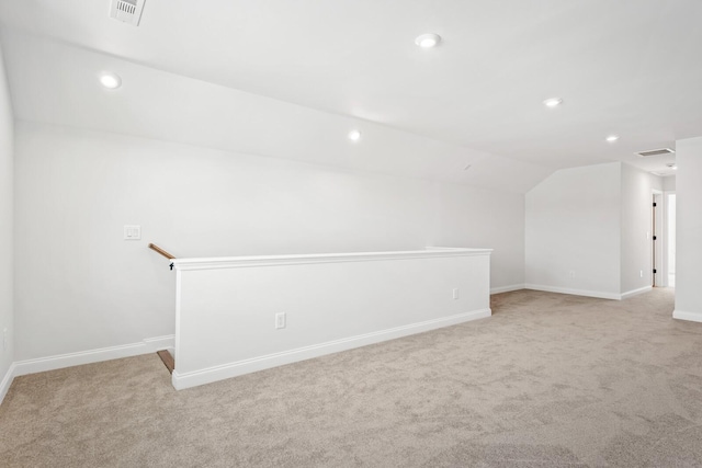 interior space with lofted ceiling, light carpet, visible vents, and recessed lighting