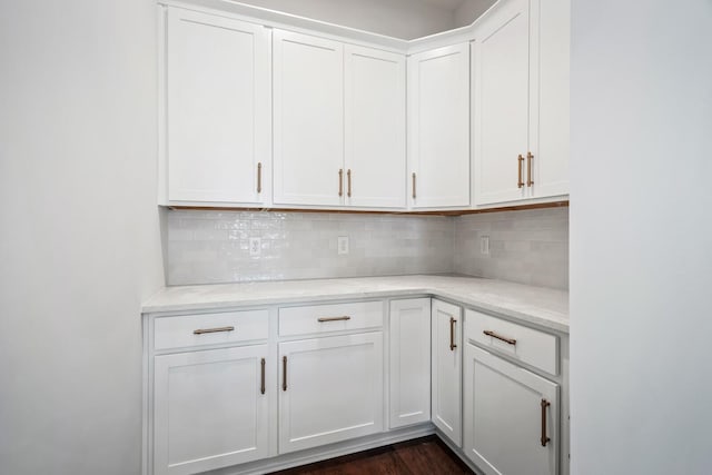 interior space with dark wood-style floors and backsplash