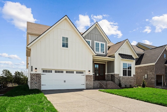 view of front of home featuring driveway, a garage, brick siding, board and batten siding, and a front yard