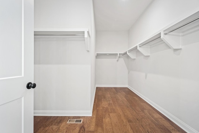 walk in closet with dark wood-style floors and visible vents