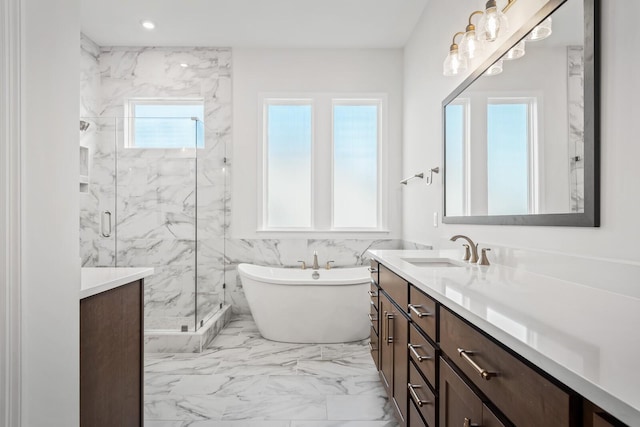 full bath with a marble finish shower, a soaking tub, marble finish floor, vanity, and recessed lighting