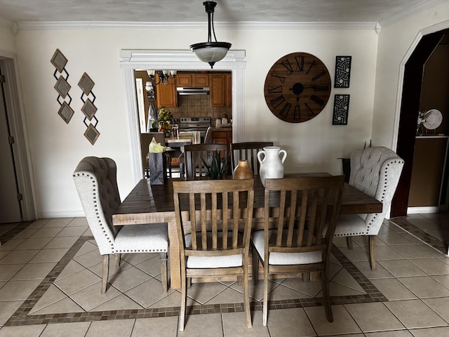 dining room featuring ornamental molding, baseboards, and light tile patterned floors