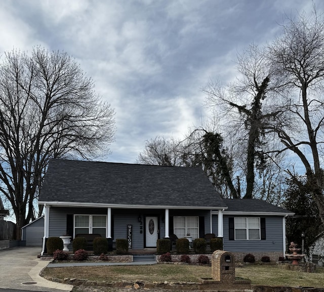 view of front of home with an outbuilding and roof with shingles