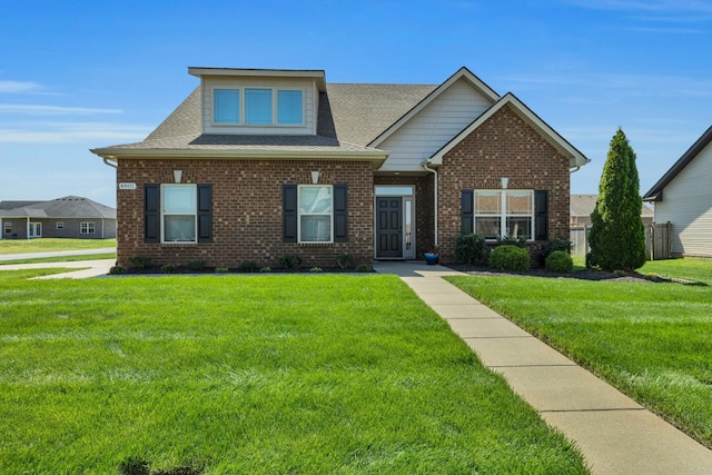 craftsman-style home with a front yard, brick siding, and a shingled roof