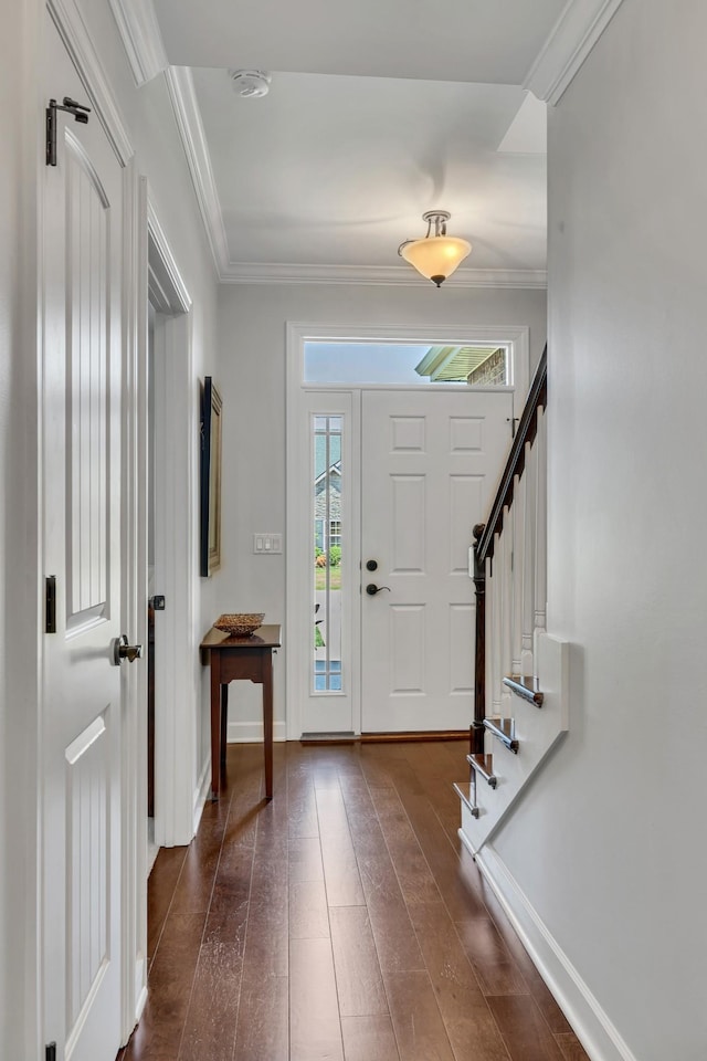 entrance foyer with stairway, baseboards, crown molding, and dark wood finished floors