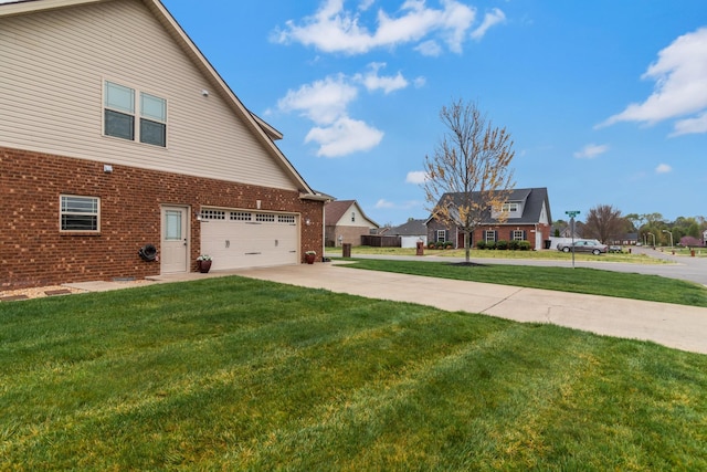 view of home's exterior with a yard, brick siding, and driveway