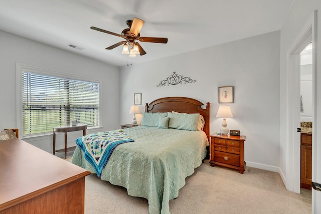 bedroom with ceiling fan, light colored carpet, baseboards, and visible vents