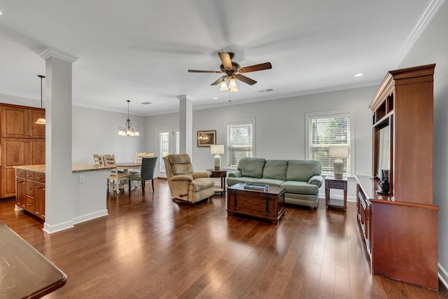 living area featuring dark wood-type flooring, ceiling fan with notable chandelier, visible vents, and recessed lighting