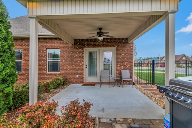 view of patio featuring fence and a ceiling fan